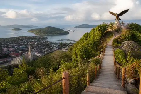 Staircase and eagle landmark above Culion town with church and harbor below