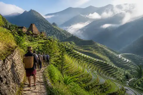 Ifugao rice terraces near Banaue with hikers on a narrow path