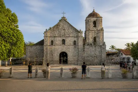 Coral-stone facade of St. Peter the Apostle Parish in Bantayan town with safety barriers