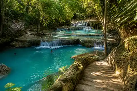 Layered turquoise pools and rope swing at Cambugahay Falls, Siquijor