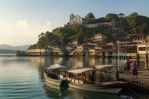 Culion heritage town with hilltop church above small boats at the port