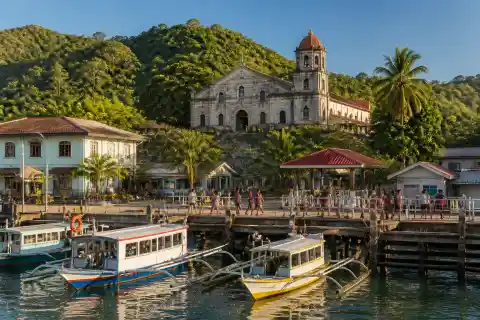 Culion town waterfront with La Immaculada Concepcion Church and small boats