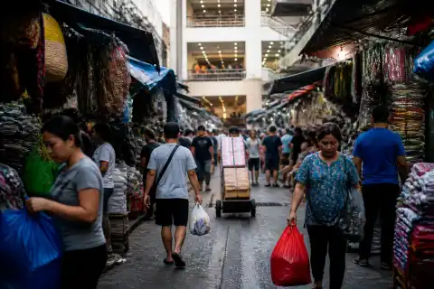Busy Divisoria shopping lane with stalls, shoppers and a mall entrance