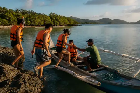 Small banca with snorkelers in Donsol Bay at sunrise
