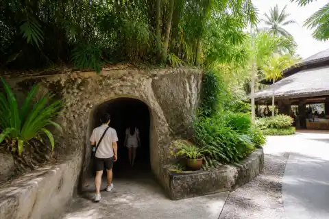 Entrance to the Japanese Tunnel at a family resort in Davao with a narrow shaded tunnel doorway and tropical landscaping