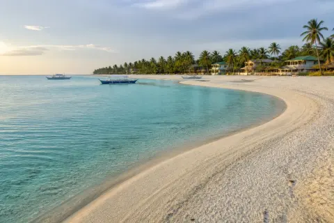 Kota Beach curved sandbar and shallow turquoise lagoon at sunrise, Santa Fe, Bantayan Island
