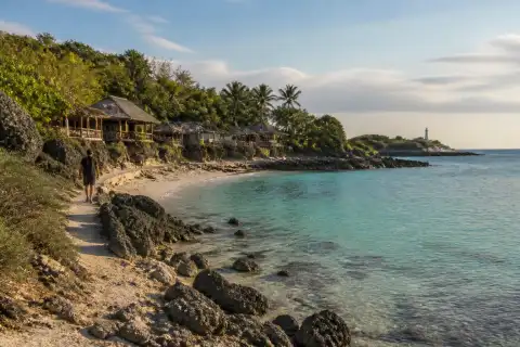 Rugged rocky cove and small sandy beach at Los Bamboos, Malapascua