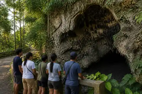 Visitors observing fruit bats clustered at a cave opening on Samal Island