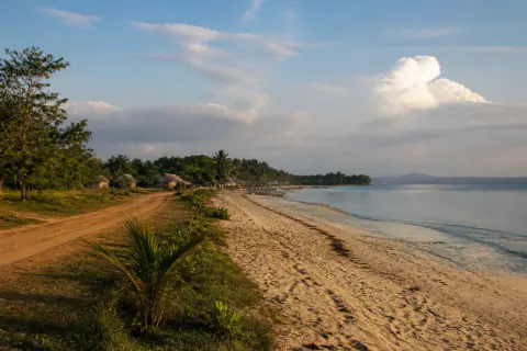 Sparse sandy shoreline and low waves on Nagtulay Beach near Alimanguan, San Vicente