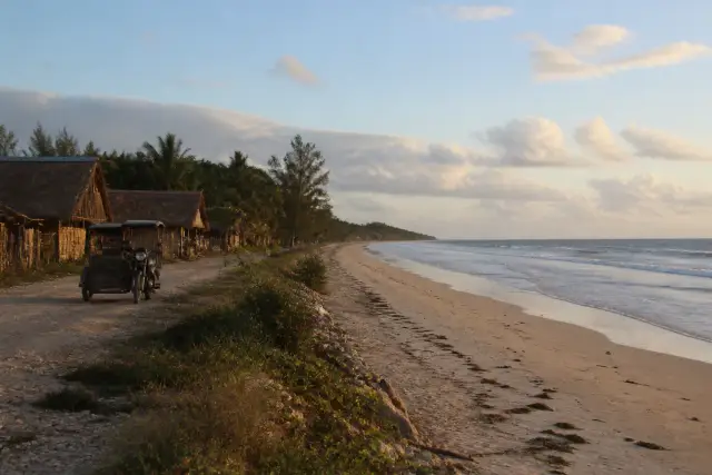 Quiet sandy beach and coastal road on northern San Vicente near Alimanguan