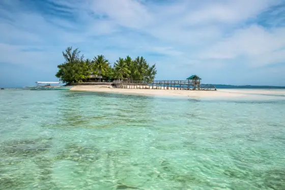 Onok (Onuk) Island shallow turquoise lagoon with stilt walkway
