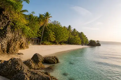 Empty rocky white-sand cove on Samal Island at sunrise