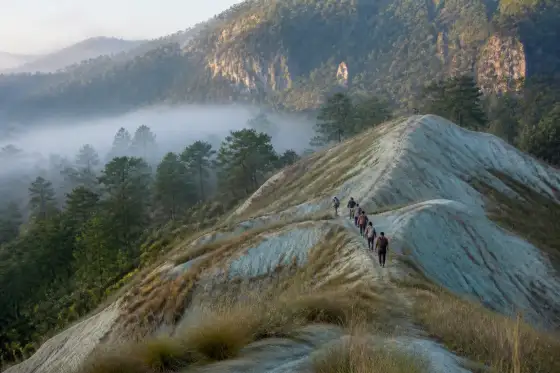 Hikers on the bluish soil ridgeline at Sagada’s Blue Soil Hills