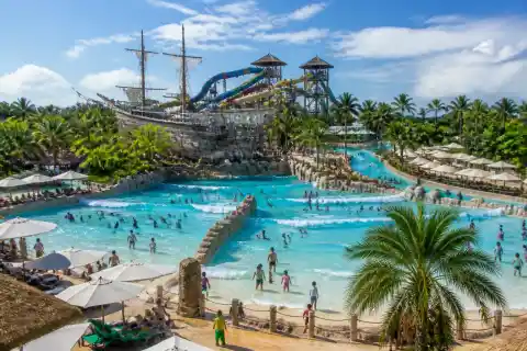 Families in the dual wave pool with slide towers and lazy river at Seven Seas Waterpark