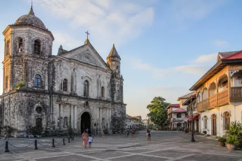 Facade of Taal Basilica and the town plaza in morning light