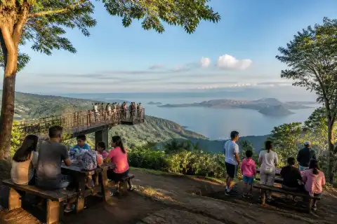 Picnic tables and visitors at a Tagaytay ridge viewpoint overlooking Taal Lake