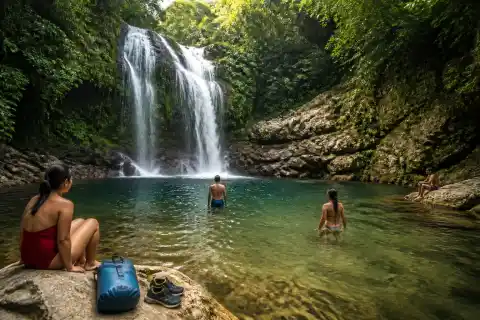 Tuasan Falls cascade and freshwater pool with swimmers in Camiguin