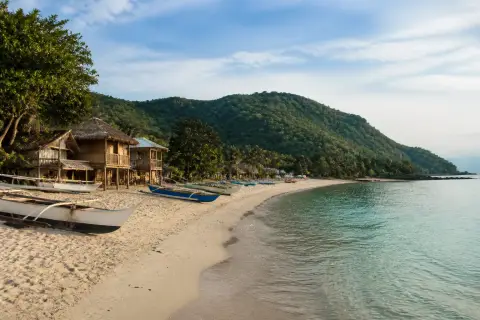Mahabang Buhangin beach on Verde Island with local banca boats and simple homestays