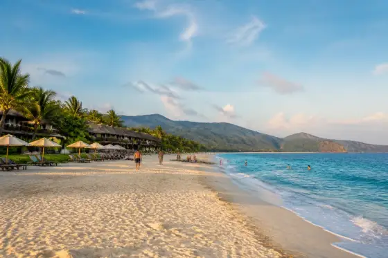 Saud Beach white-sand shoreline, calm blue sea and low beachfront cottages