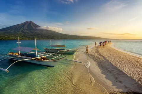 White Island sandbar off Yumbing, Camiguin with banca boats and volcanic backdrop