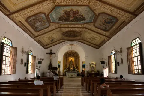 Interior of Santo Niño de Anda Parish Church showing painted ceiling and nave