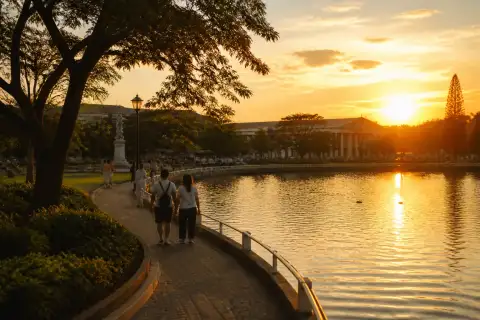 Capitol Park and Lagoon at sunset with people walking along the path