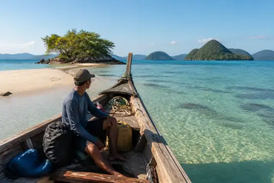 Wooden expedition boat near a sandbar with vegetated islets in Balabac