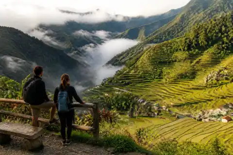 Banaue rice terraces and village seen from a roadside viewpoint at sunrise