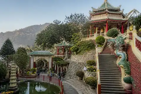 Bell Church courtyard with dragon statues and Chinese-style roofs on a hillside near Baguio
