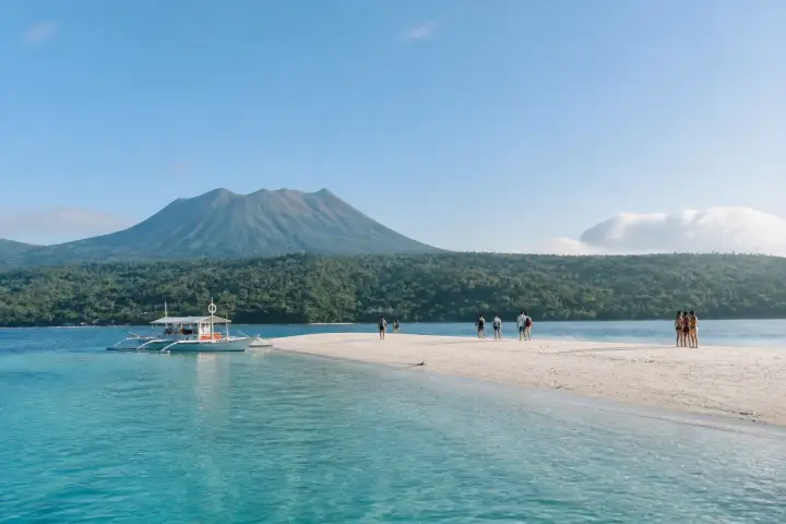 White Island sandbar with Hibok‑Hibok volcano in the background and a banca on the shore
