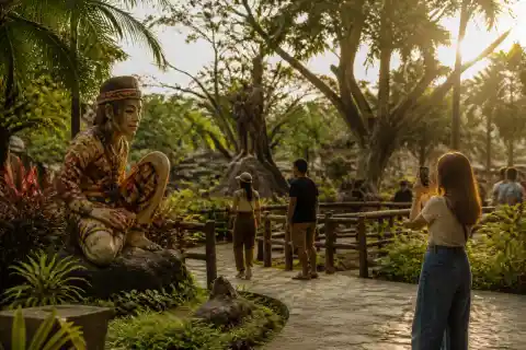 People’s Park sculptures and tropical gardens with visitors in late afternoon light
