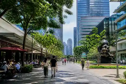 Bonifacio High Street pedestrian promenade with trees and modern buildings in BGC