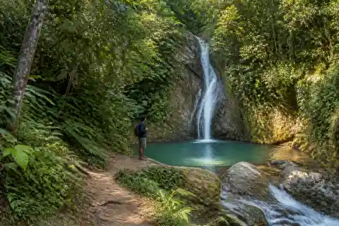 Small tropical waterfall and local guide near Cagayan de Oro