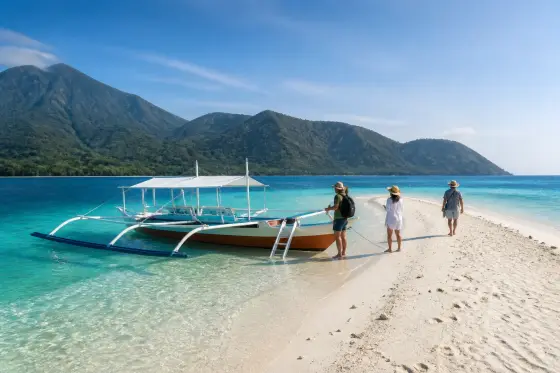 White Island sandbar with a small banca and Camiguin volcanic coastline