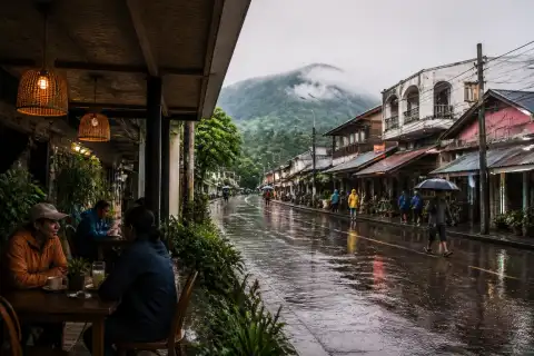 Covered café and wet street in Mambajao, Camiguin, during light rain