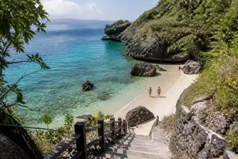 Rock‑framed cove and steep staircase at Cancua‑ay Beach, Oslob