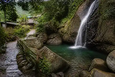 Narrow waterfall and rock pool in a rural Taytay, Palawan setting