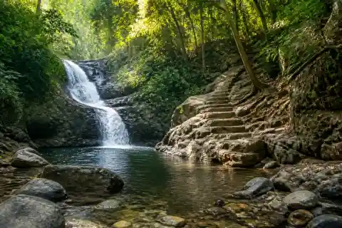 Small shaded cascade and rocky river pool at Catanico Falls near Cagayan de Oro