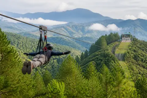 Rider on Dahilayan's 840m prone zipline over Bukidnon highlands