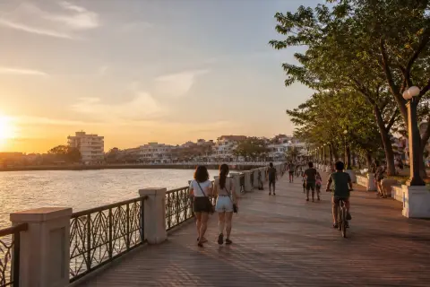 Iloilo River Esplanade boardwalk at sunset with walkers and cyclists