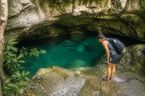 Small enclosed limestone cave pool with low ceiling at Kaligoon, Anda, Bohol