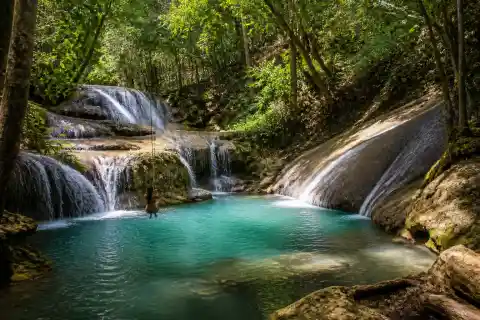 Small forest pool at Lagaan Falls with rope swing and rock slide