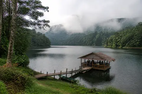 Lake Danao highland lake with a floating cottage and forested hills