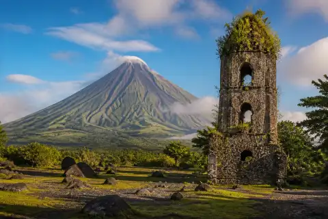 Mayon Volcano rising above the Cagsawa Ruins at sunrise