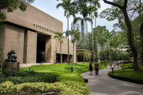 Ayala Museum exterior with Greenbelt Gardens and visitors in Makati