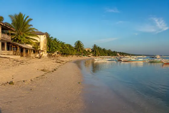 Bounty Beach, Malapascua, with small boats on the sand at sunrise