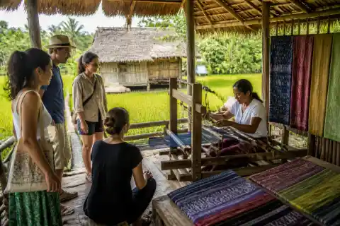 Local weaver demonstrating a traditional loom at Motag Living Museum with visitors