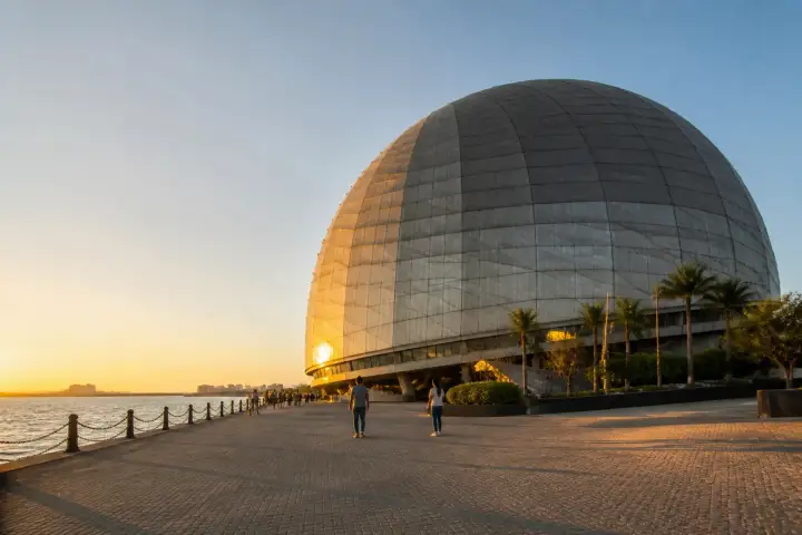 Museo del Galeón dome and Bay City waterfront in Pasay at sunset