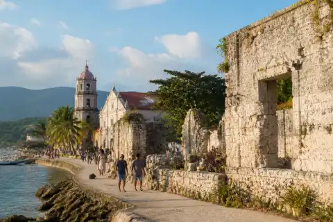 Cuartel ruins and waterfront with Oslob church in morning light
