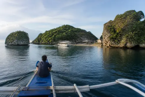 Boat approaching small green islands at Hundred Islands, Pangasinan